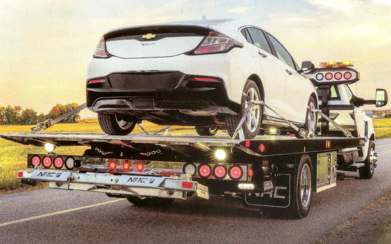 tow truck towing car on a flatbed san diego